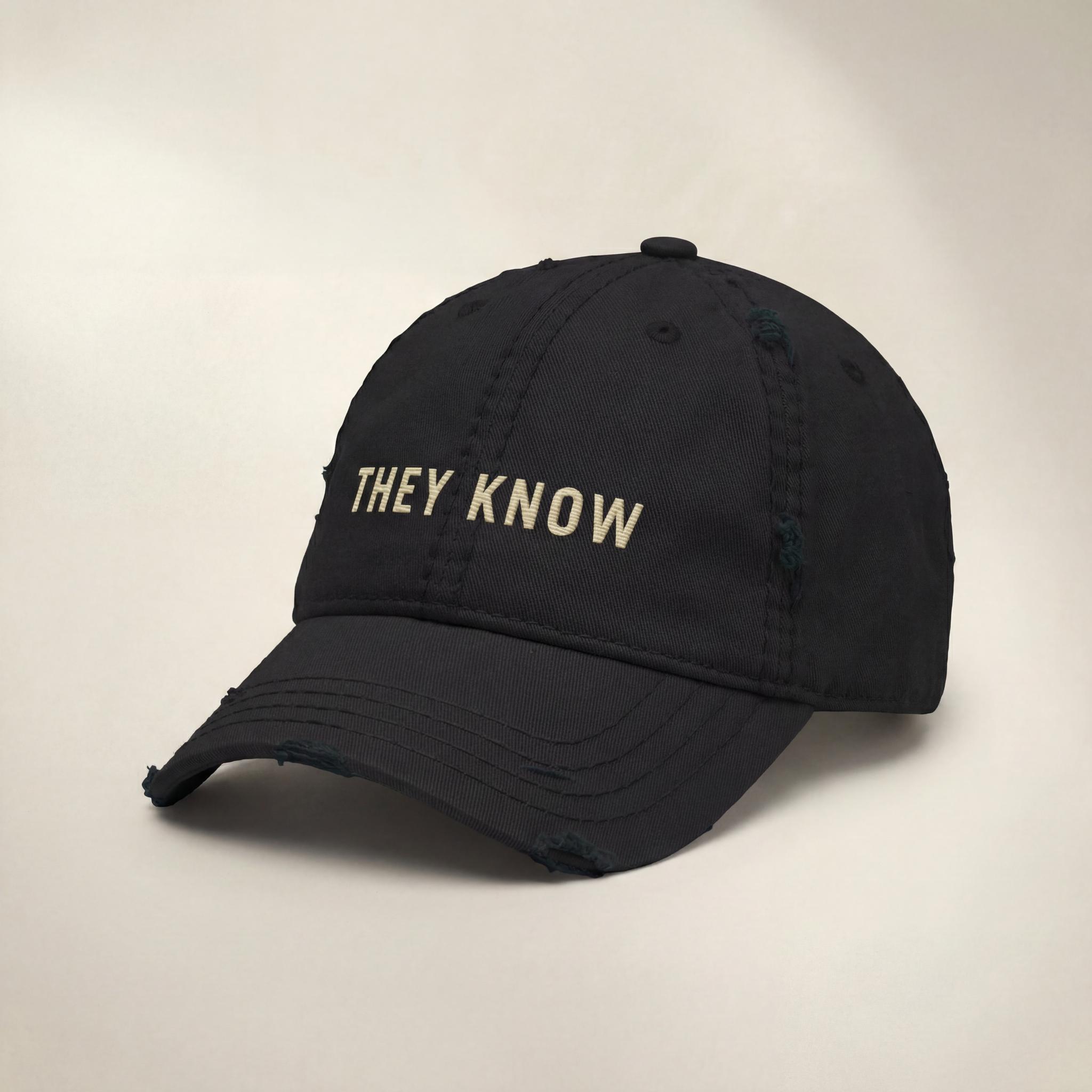 Black THEY KNOW embroidered hat shown from a side angle.