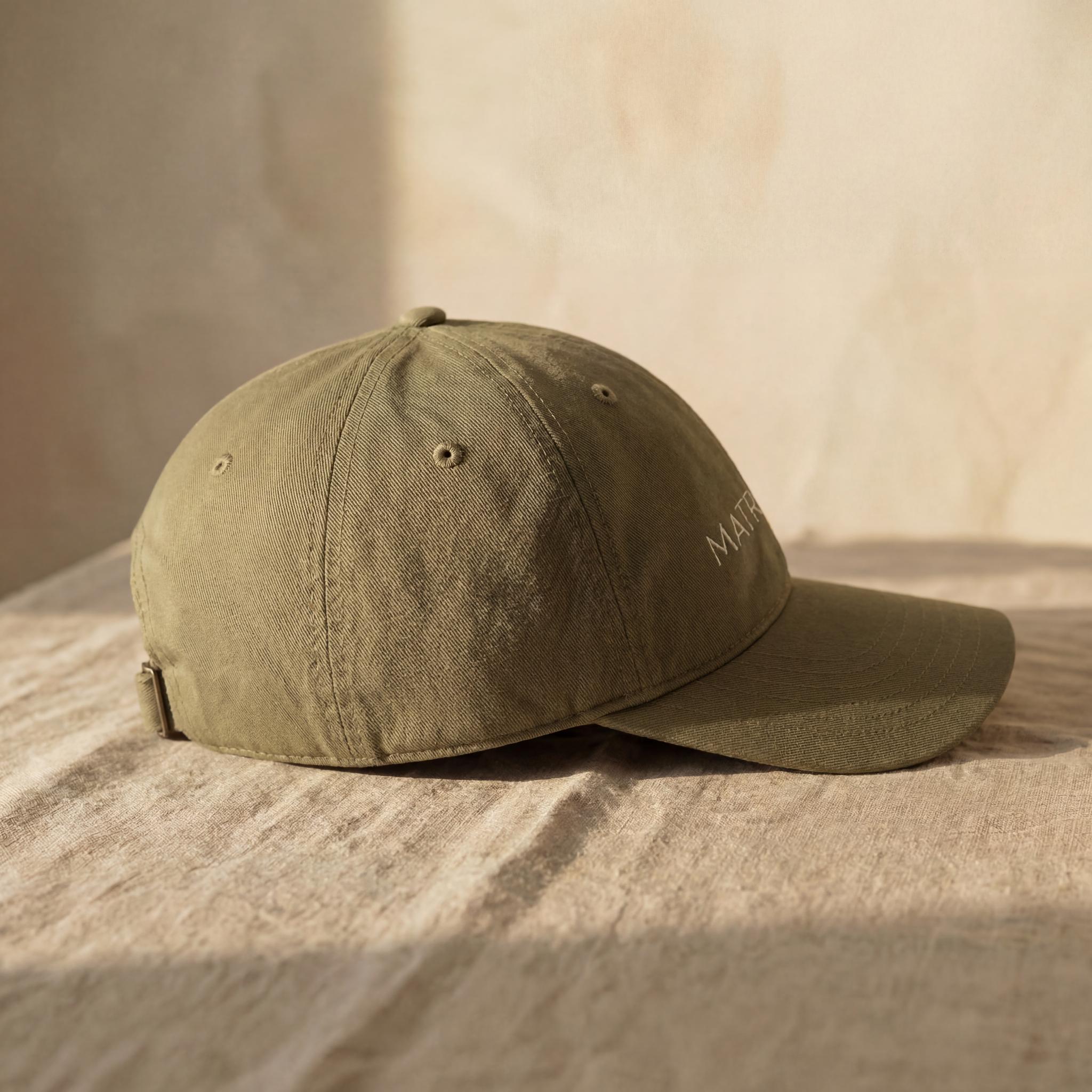 Olive MATRIARCH embroidered cap shown from a side angle.