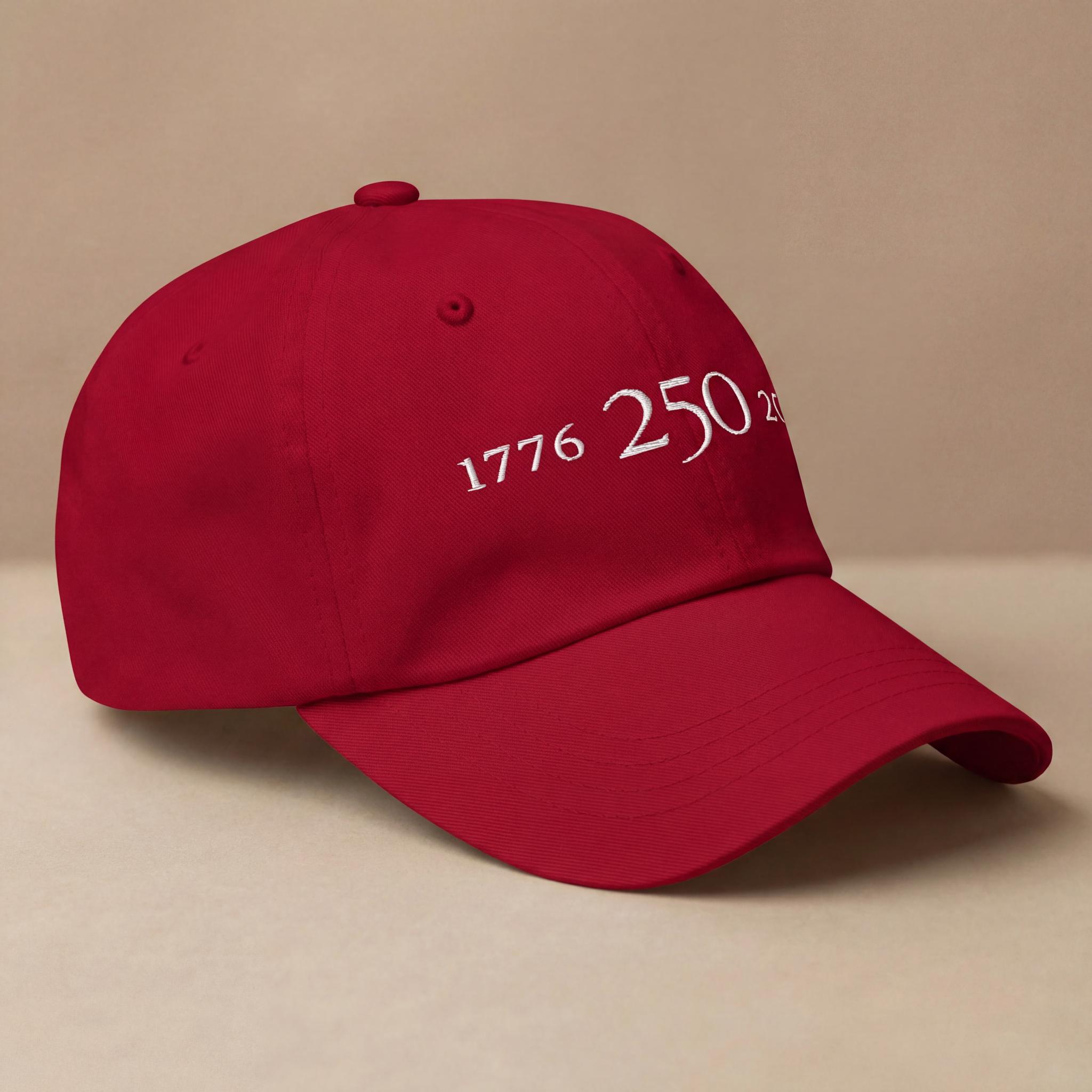 Red 1776–2026 embroidered hat shown from a side angle.