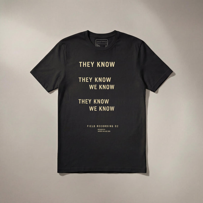 Black They Know We Know graphic tee with front design visible.